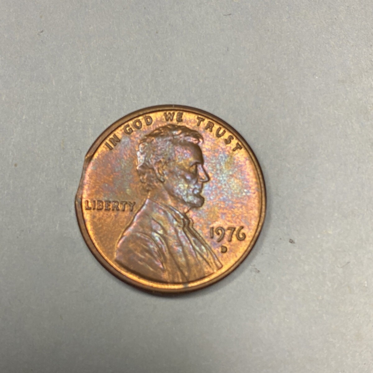1976 penny struck on dime planchet shown next to normal 1976 cent illustrating smaller diameter and reeded edge