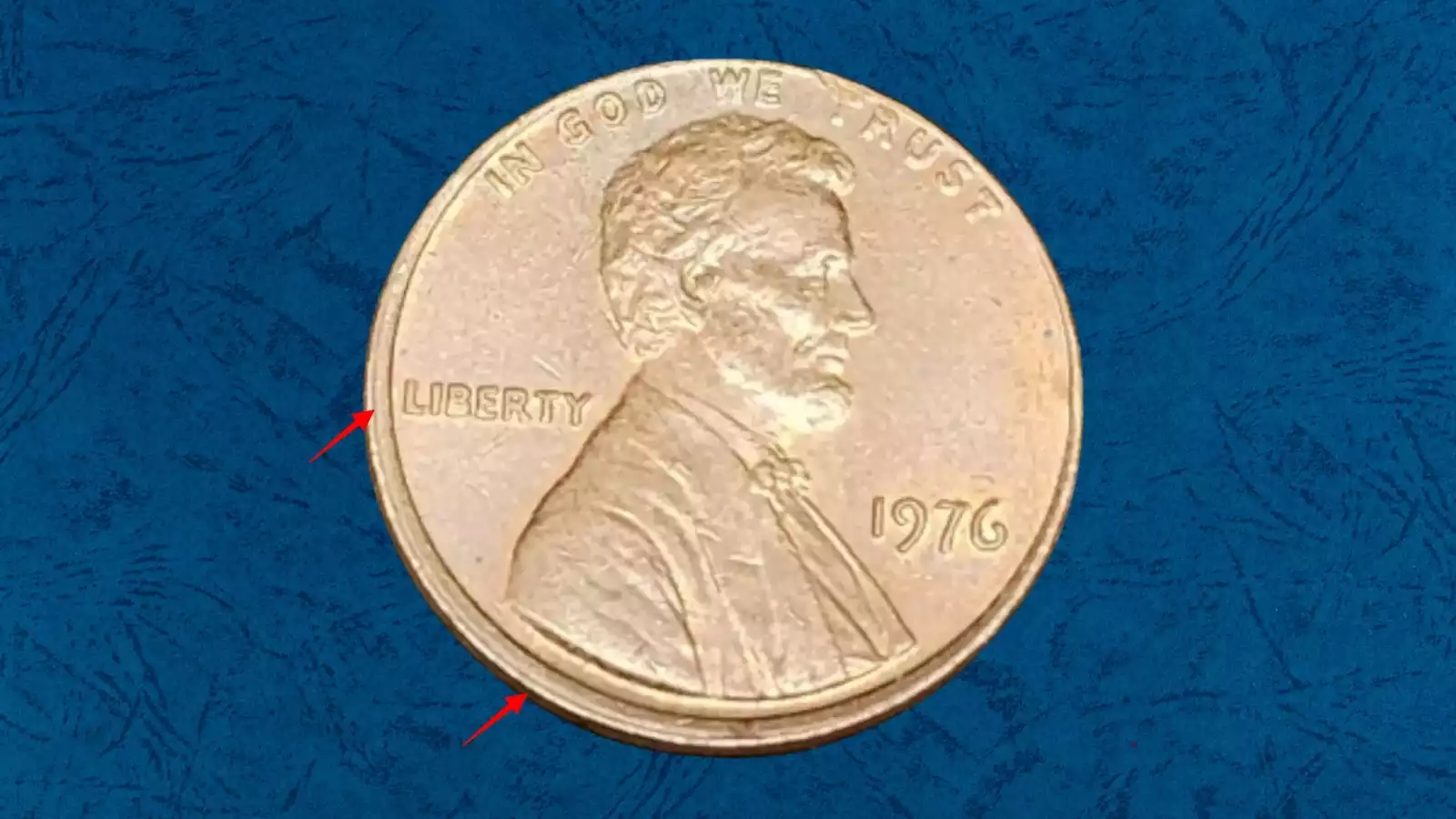 1976 penny off-center strike error showing blank crescent and partial Lincoln portrait with date still visible