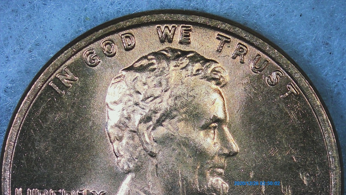 1976 penny major die cud error showing raised blank blob at rim where die piece broke away obliterating part of the design
